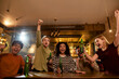 © Svitlana - Shout it out. Happy friends in the bar watching sports match on TV together, drinking beer and celebrating victory. People, leisure, friendship and entertainment concept