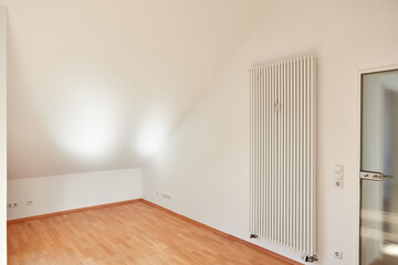 Canvas Print - Empty room in attic apartment with radiator