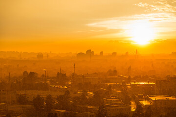 Wall Mural - Cityscape with sunset in big city, moderm buildings under dramatic sunset sky