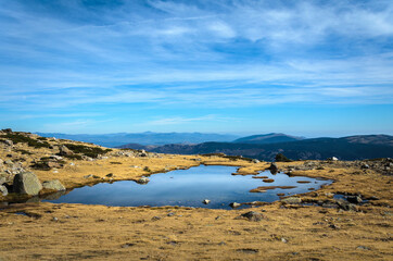 Wall Mural - Small lake on a rocky mountain landscape on Guadarrama mountain range, Peñalara, Madrid, Spain