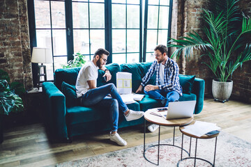 Wall Mural - Focused businessmen working on documents together