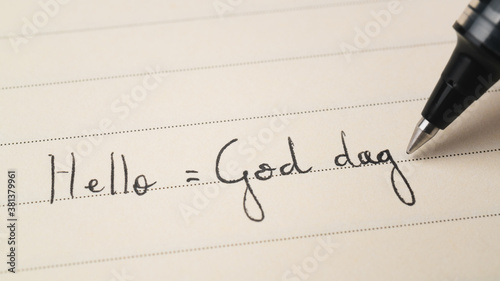 Fotomural Beginner Swedish or Norwegian language learner writing Hello formal word God dag
