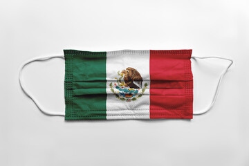 Wall Mural - Face mask with Mexico flag printed, on white background, isolated