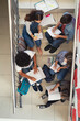 © Rido - College students sitting on staircase at school and studying