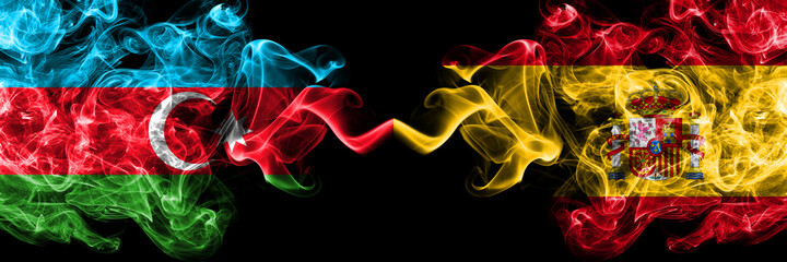 Azerbaijan, Azerbaijani vs Spain, Spanish smoky mystic flags placed side by side. Thick colored silky abstract smoke flags