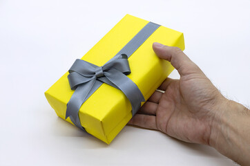 Hands holding  gift box with as a present for Christmas, new year, valentine day