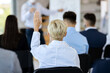 © Drazen - Rear view of businesswoman asking question on a seminar in board room.