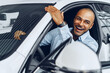 © fotofabrika - Portrait of a handsome happy African American man sitting in his newly bought car