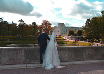 bride and groom walking in the park