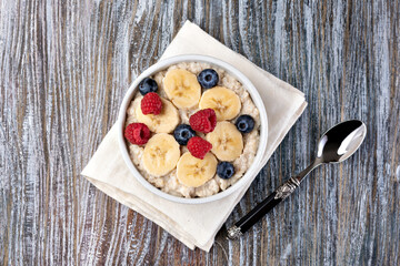 Wall Mural - prepared oatmeal with fruits and berries