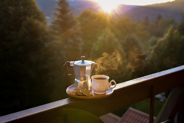 Sunrise coffee. Breakfast with coffee in nature. Dawn in the forest with coffee. Beautiful sunrise. Morning cup of hot drink with mountain background at sunrise. World coffee day. Sunrise tea