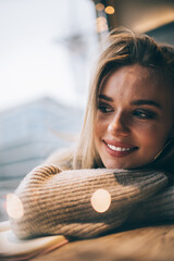 Wall Mural - Close up view of pretty Caucasian hipster girl 20 years old enjoying resting time for thinking and dreaming, carefree female teenager with perfect skin, hair and white veneers recreating in soft focus