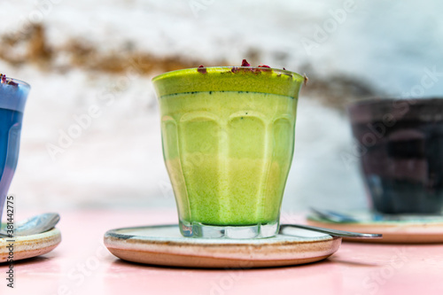 Fotomural Glasses of Super Lattes such as Butterfly Matcha from organic blue matcha and nut milk, Rose Matcha from Organic Japanese green tea powder infused with rose water