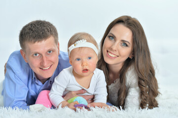 Portrait of happy parents playing with daughter