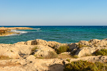 Wall Mural - rocky beach on the blue sea on a Sunny evening