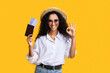 © Prostock-studio - Ready For Travel. Happy woman with passport and tickets gesturing ok sign