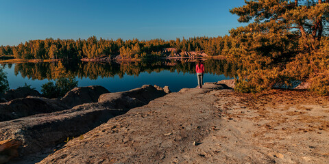 Woman standing near the pine tree admiring the landscape 