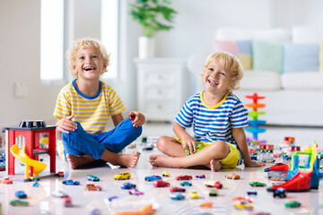 Kids play with toy cars. Children playing car toys