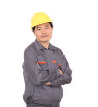 Migrant Worker Wearing Yellow Hard Hat Holding Hands Standing In Front Of White Background