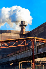 View of old factory with pipe with smoke. Air pollution, environmental damage