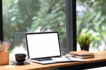 Fototapete - Modern workspace with blank screen desktop laptop and office supplies on wooden desk.