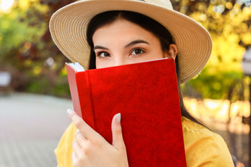 Poster - Beautiful young woman reading book in park