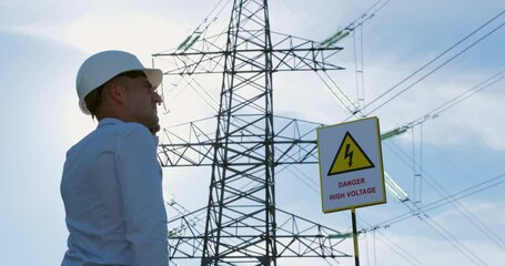 Wall Mural - a man in a white protective helmet stands next to a 