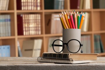 Wall Mural - Stack of vintage books and colorful pencils on the desk