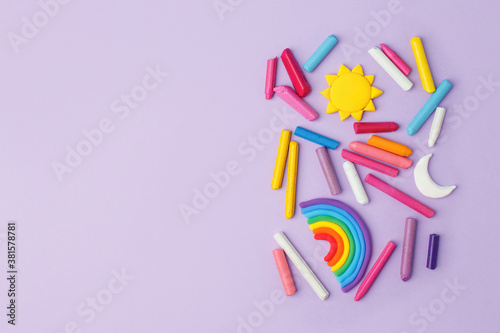 Fotomural Abstract purple pastel background with many kids accessories from clay, wax chal