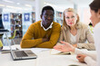 © JackF - Students sitting in library, working with professor. High quality photo