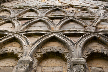 Wall Mural - Stone carving on a wall of a medieval priory abbey