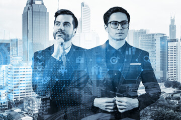 Two handsome businessman in suits thinking about career opportunities at research and development department at international consulting company. Hologram icons over Kuala Lumpur background.