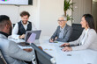 © Sanja - A group of business partners sit in the conference room and agree on new business contracts, seem satisfied with the negotiations