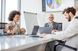© Sanja - A group of business partners sit in a conference room and agree on new business moves for their company, seem satisfied