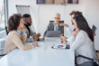 © Sanja - A group of business partners are sitting in the conference room, negotiating new contracts