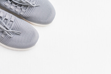 Grey sneakers, white background, cropped image, copy space, top view