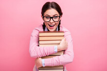 Close-up Portrait Of Her She Nice Attractive Pretty Amazed Cheerful Cheery Addicted Genius Brown-haired Teenage Girl Embracing Pile Book Science Lover Isolated On Pink Pastel Color Background