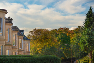 Blonde Sandstone Terrace Houses and Autumn Leaves on Trees on a Residential Street in the Southside of Glasgow Scotland