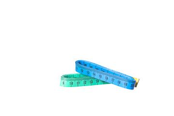 Two stacked colorful tailor metric measuring tapes isolated on white background blue and green color. Sewing meter. Traditional tailoring equipment. DIY concept.