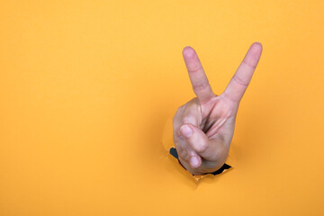 Woman's hand is show two fingers up. Finger symbols of peace strength fight, victory symbol