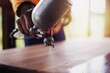 © Krailas - The painter is spraying the wood color to make the wooden floor beautiful.
