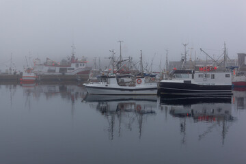 Wall Mural - Fog in port of the polar town Vardo of the coast of the Barents sea, Varanger national scenic route in Finnmark, Norway