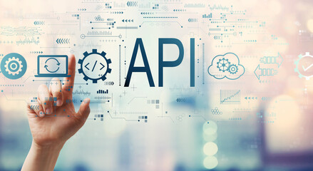 API - application programming interface concept with hand pressing a button on a technology screen