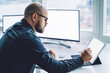 © BullRun - Serious man writing on graphic tablet in office
