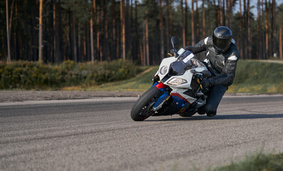 Wall Mural - Handsome motorcyclist riding his super sport motorcycle.