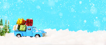 Christmas Presents On Blue Truck Riding Through A Snowy Forest