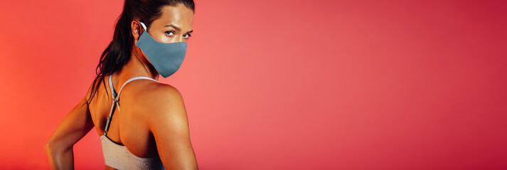 Wall Mural - Sportswoman in protecitve face mask