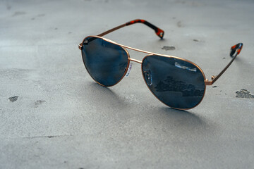 Sticker - New dark aviator glasses on grey concrete background