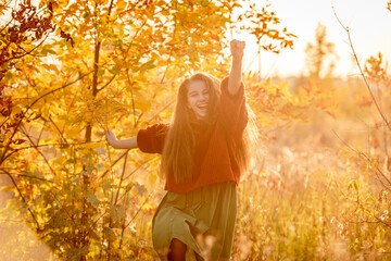 Happy teenage girl walking in autumn nature