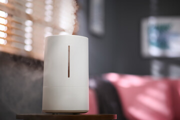 Poster - Modern air humidifier on table indoors. Space for text